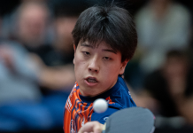 TTBL-Finale: ASC Grünwettersbach kämpft in Grenzau um versöhnlichen Saisonabschluss Male table tennis player in blue/orange jersey lunges to strike a ball toward the net during a match.